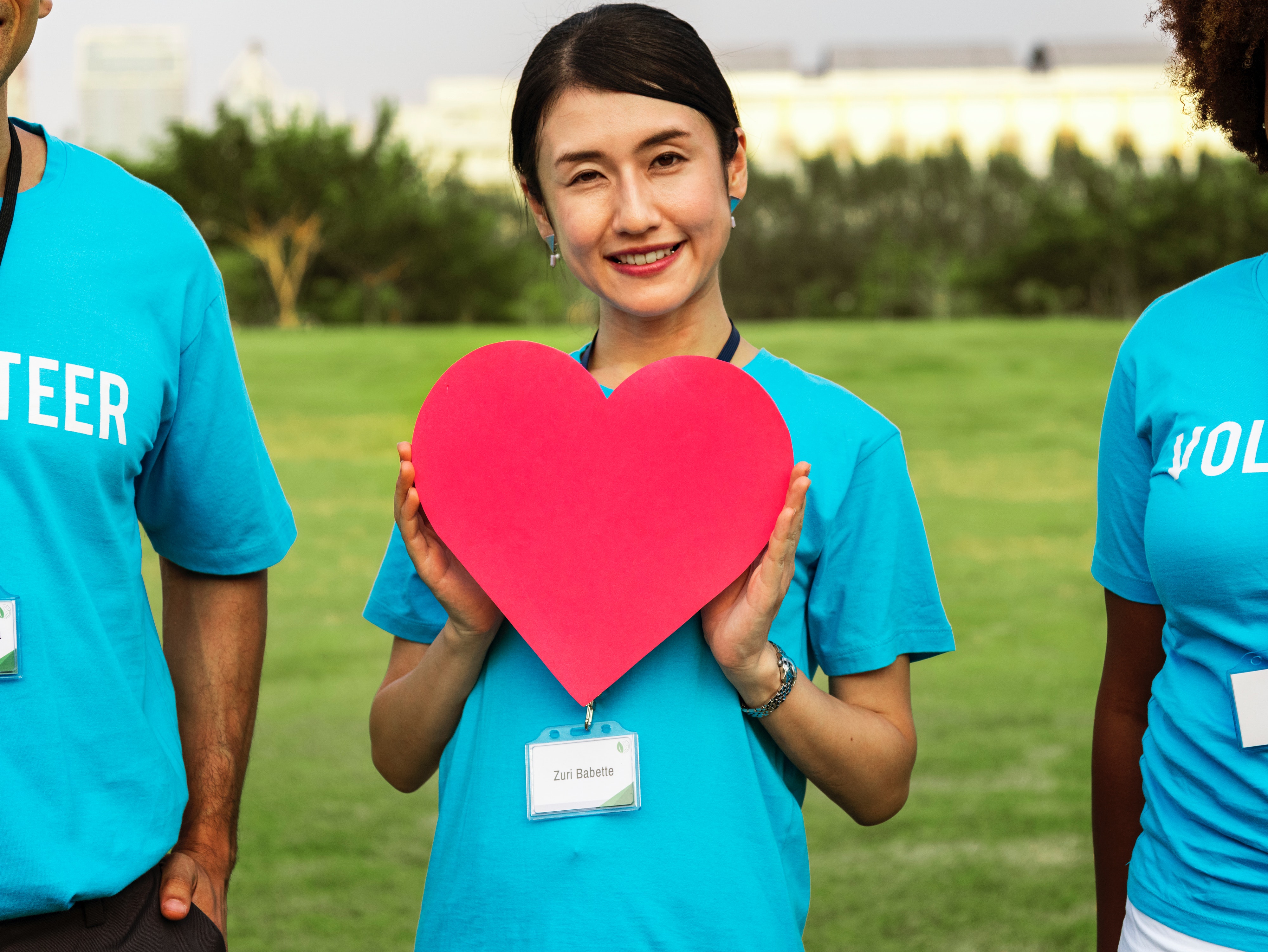 Volunteer holding cardboard heart